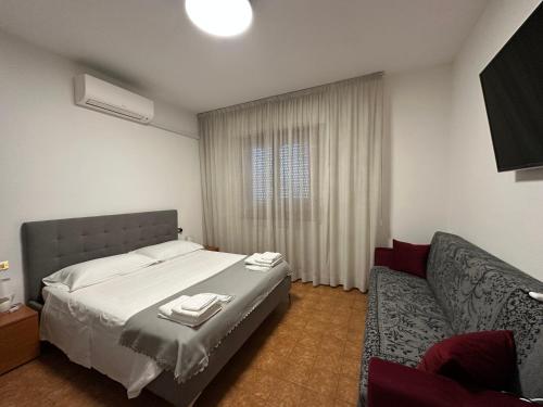 a bedroom with a bed and a couch at La madonnuccia in Deruta
