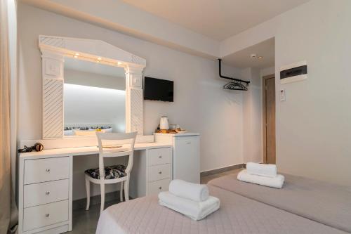 a bedroom with a desk and a bed with a window at A&B Rooms Rodos Center in Rhodes Town