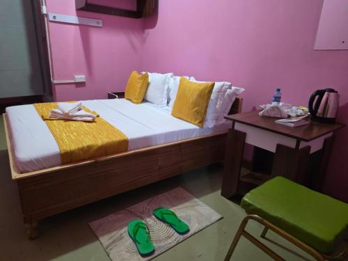 a bedroom with a bed and a table and a chair at EMJAYS guest house in Eldoret