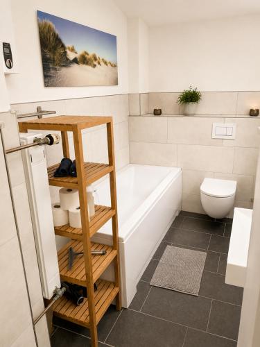 a bathroom with a tub and a toilet and a sink at Troisdorf - City - 64Qm - 1 bis 3 Schlafplätze in Troisdorf