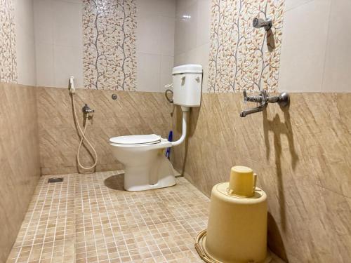 a bathroom with a toilet in a shower stall at Villa Shakthi in Pondicherry