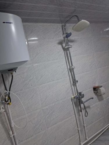 a shower in a bathroom with a shower head at David traditional Oda in Shuakhevi