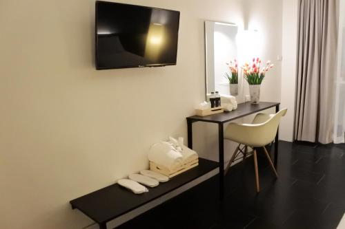 a hotel room with a desk and a mirror at Shane Hotel in Chiang Mai
