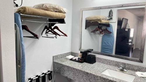 a bathroom with a sink and a mirror at Studio 6 Suites Opelousas, LA in Opelousas