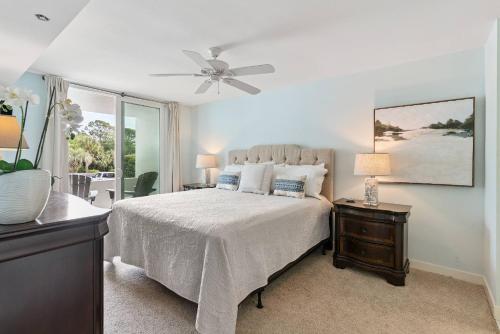a bedroom with a bed and a ceiling fan at North Breakers 201 in Saint Simons Island