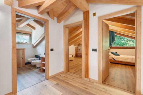 a room with wooden ceilings and a hallway with doors at Maso Rubino in Rabbi