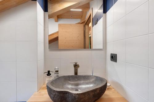 a bathroom with a large stone sink in a room at Maso Rubino in Rabbi