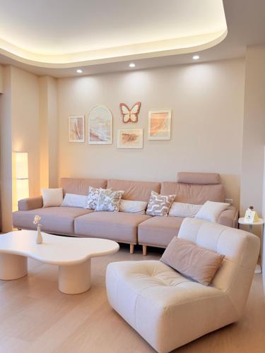 a living room with a couch and a table at 想睡覺民宿 in Hsia-ch'ing