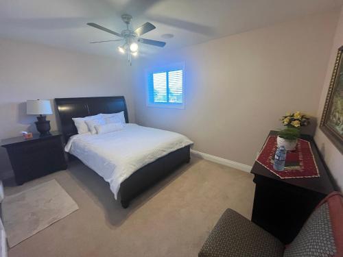 a bedroom with a bed and a ceiling fan at Green Leaf Home Stay in West Kelowna