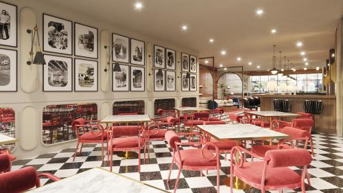 a restaurant with tables and chairs and pictures on the wall at Holiday Inn & Suites Tijuana Downtown by IHG in Tijuana