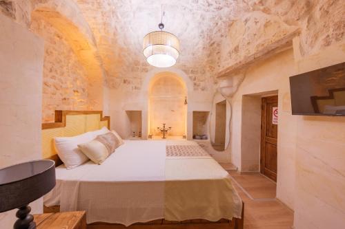 a bedroom with a bed in a room with a ceiling at Old Town Urfa in Urfa