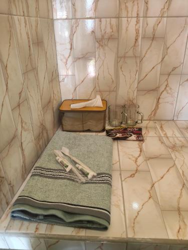 a bathroom with two towels on a counter at Penginapan Griya Safira in Taliwang