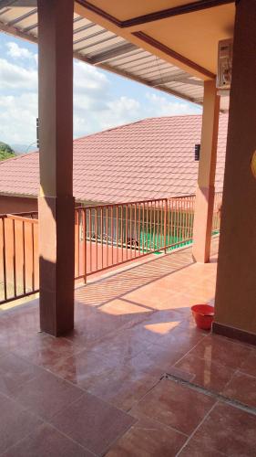 an empty patio with a fence and a deck at Penginapan Griya Safira in Taliwang