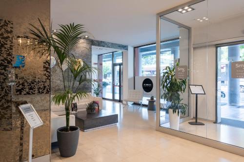 a lobby with potted plants in a building at Smy Bologna Centrale in Bologna