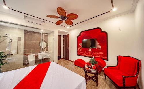 a bedroom with a red bed and a bathroom at Lake Hotel Sóc Sơn in Sóc Sơn