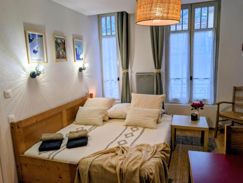 a bedroom with a large bed with two pillows at Cocon Luchon in Luchon