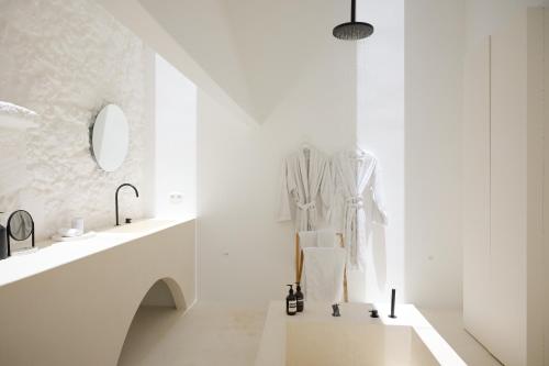 a white bathroom with two sinks and a mirror at Casa Montelongo - Adults Only in La Oliva