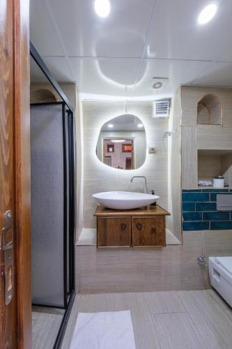 a bathroom with a tub and a sink and a mirror at Old Town Urfa in Urfa