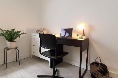 a desk with a laptop and a chair in a room at Mosel Appartment in Briedel in Briedel