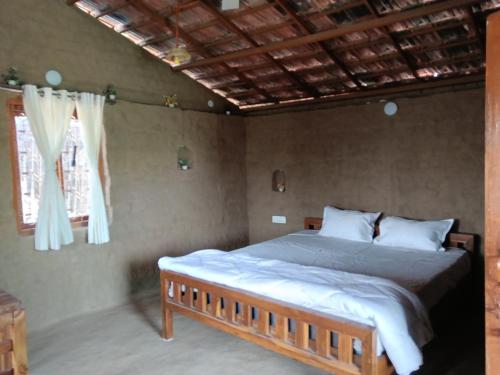 a bedroom with a large bed in a room at Ishika Homestay in Maheshwar