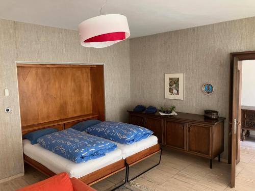 a bedroom with a bed and a wooden headboard at Padiglione Castagneto in Castasegna