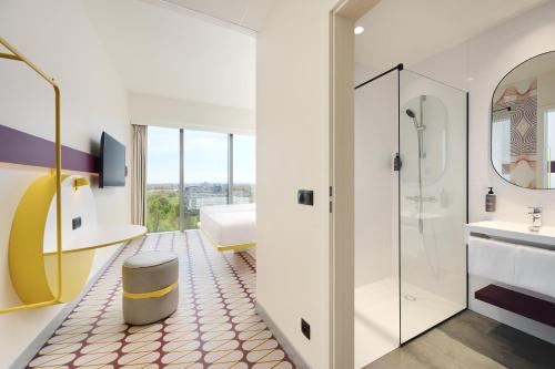 a bathroom with a shower and a sink and a toilet at Prize by Radisson, Wroclaw Sky Tower in Wrocław