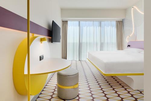 a hotel room with a bed and a desk at Prize by Radisson, Wroclaw Sky Tower in Wrocław