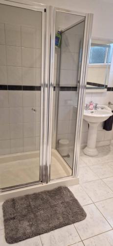 a bathroom with a shower and a sink at Wee Cumbrae View in Millport