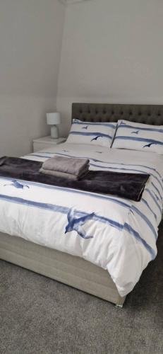 a bedroom with a bed with a dolphin on it at Wee Cumbrae View in Millport