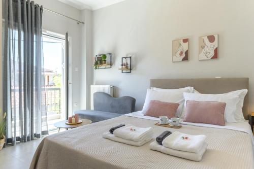 a bedroom with a bed with two towels on it at Rania's Seaside Nest- Steps from the Beach in Kiaton