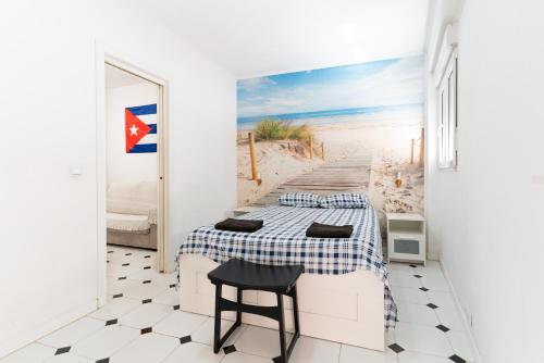 a bedroom with a bed and a boardwalk to the beach at El Rinconcito Cubano en el Centro in Almería
