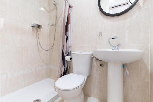 a bathroom with a toilet and a sink and a shower at El Rinconcito Cubano en el Centro in Almería