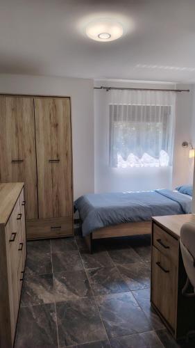 a bedroom with two beds and a window at Holiday house Bliss in Kumrovec