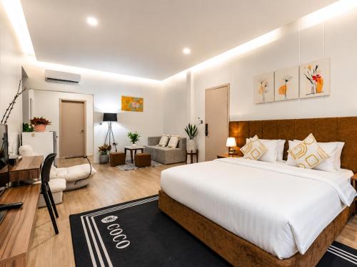 a bedroom with a large bed and a living room at YUSETH Private Villa in Phumi Ta Phul