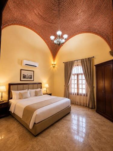 a bedroom with a large bed and a large window at Luxor Mountain View in Luxor