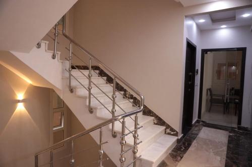 a staircase in a building with a metal railing at جراند فاندا سويتس الغردقه Grand Vanda Suites Hurghada in Hurghada