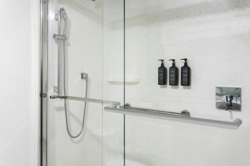 a shower with a glass door and two bottles at Marriott Isla Verde Beach Resort in Carolina