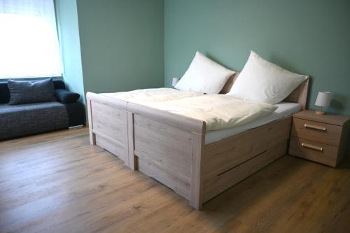 a bed with two pillows on it in a room at Ferienwohnung Talblick Wilthen in Wilthen