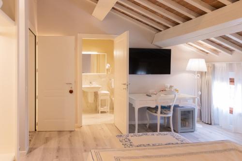 a living room with a table and a desk at Villa Mirandola in Mirandola