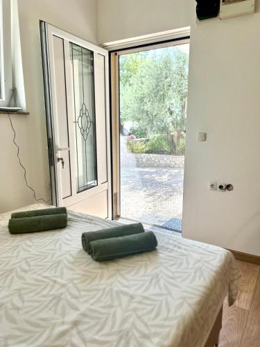 a bedroom with a bed with two green pillows on it at Marica & Kata in Vrgorac