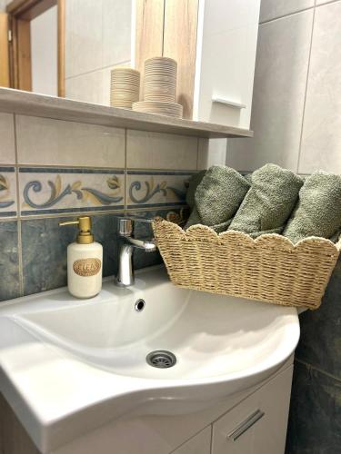 a bathroom sink with a basket on top of it at Marica & Kata in Vrgorac