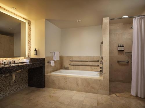 a bathroom with a tub and a shower and a sink at Fairmont Pittsburgh in Pittsburgh
