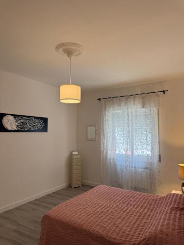 a bedroom with a bed and a window at AuraHouse in Mignanego