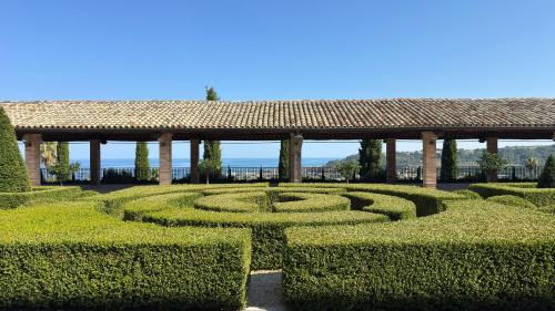 a hedge maze with a pavilion in the background at B&B Dimora Aura in Cupra Marittima