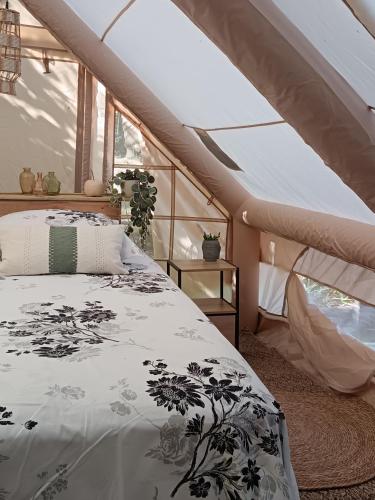 a bedroom with a bed in a attic at THOUARS Rivière LODGE KAËLI in Maulais