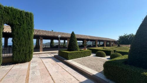 a garden with a pavilion and trees and bushes at B&B Dimora Aura in Cupra Marittima