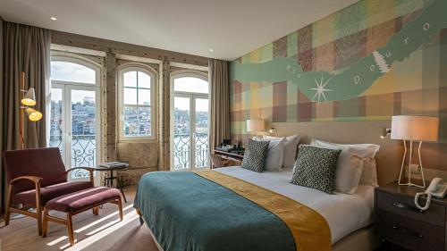 a hotel room with a large bed and a chair at Pestana Vintage Porto Hotel & World Heritage Site in Porto
