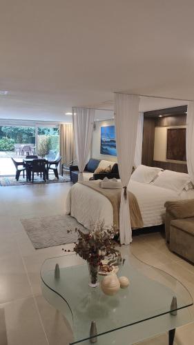 a large bedroom with two beds and a table at Casaloft994 in Bento Gonçalves