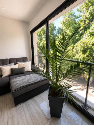 a living room with a couch and a large window at Villa 280 m2 in Sète