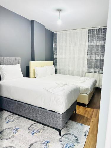 a bedroom with two beds and a window at Arden home in Van